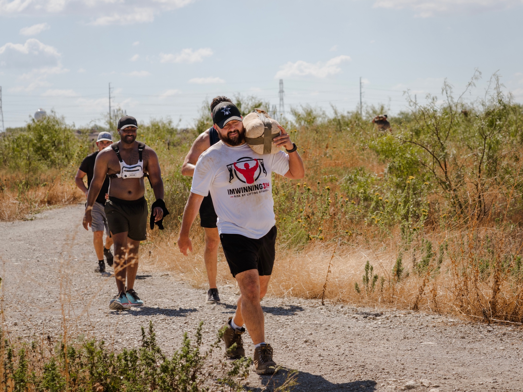 Members rucking with sandbags on the trail